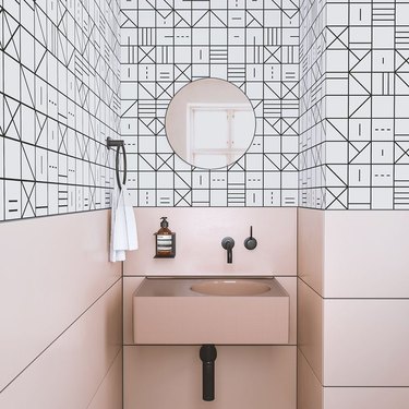 A bathroom with pink and black design details