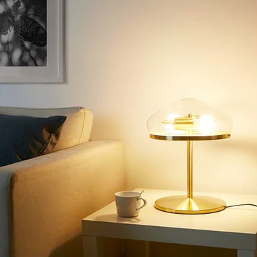gold lamp near a couch