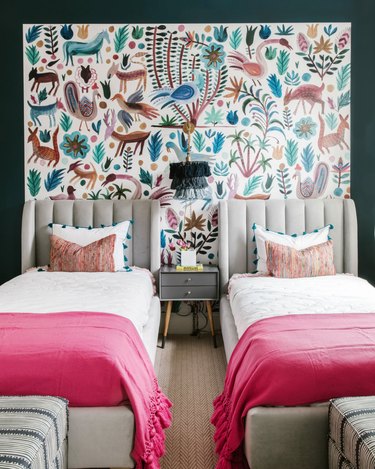 bohemian bedroom lighting idea with tasseled wall sconce hanging between two beds