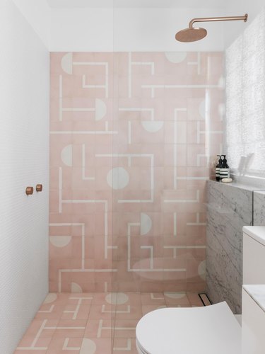 A bathroom with a pink shower
