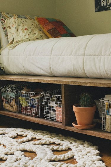 Wooden shelves with wire storage baskets and a cactus