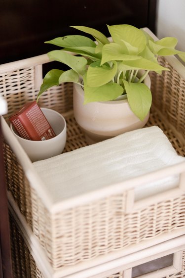Basket with white towels and plant