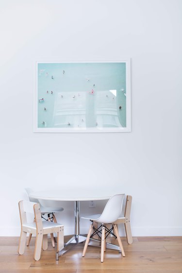 Modern artwork, table, and chairs in Meakins home