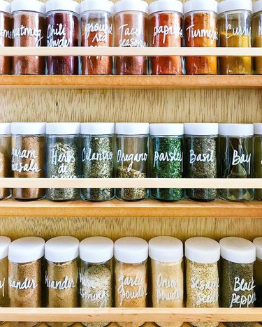 organized small pantry closet with spice rack