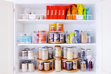 organized small pantry closet with lazy Susans