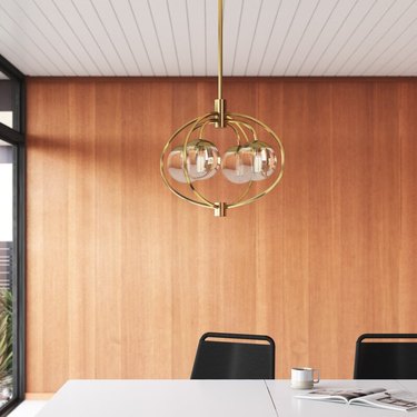 Gold and glass contemporary dining room lighting above table
