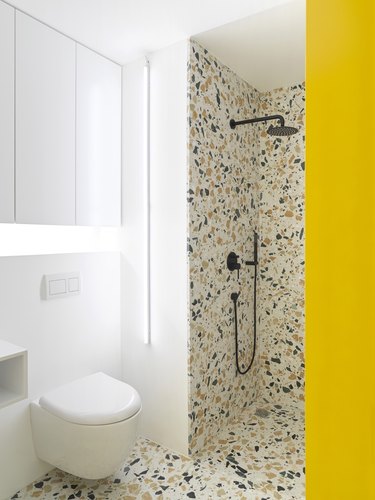 yellow and white contemporary shower with terrazzo