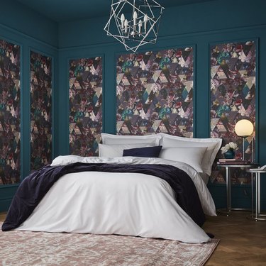 bedroom with teal wall and floral wallpaper