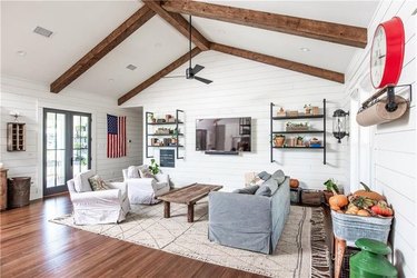farmhouse living room interior with wooden beams and white walls