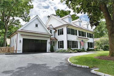 white house exterior with black garage door