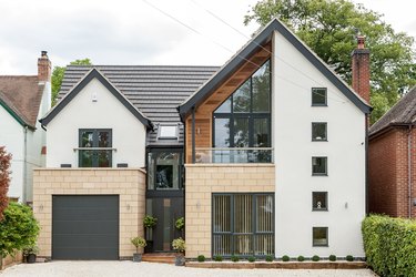 modern exterior with gable roof and black garage door