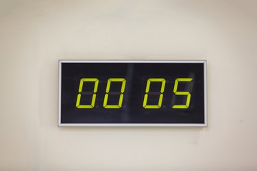Black digital clock on a white background showing time hours minutes