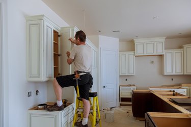 Man installing kitchen cabinets door