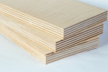 Three light plywood boards stacked