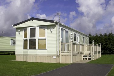 Mobile home with vinyl skirting and stairs 