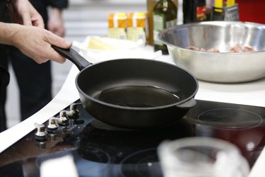 Frying pan with vegetable oil in the kitchen.Vegetable oil on a frying pan. Preheat the oil