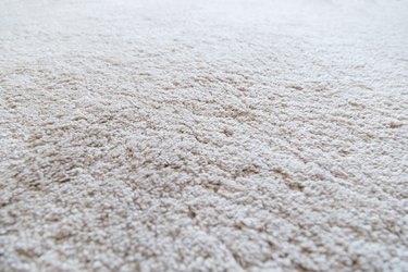 Close-up of a white shaggy carpet, shallow depth of field