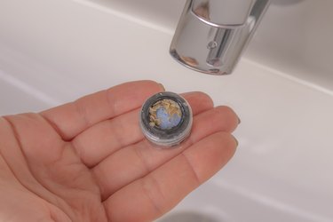Faucet aerator with scale buildup.