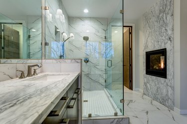 Incredible marble bathroom with fireplace.