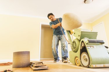 Man refinishing floors.