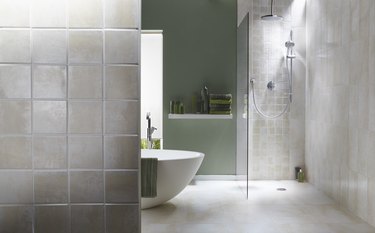 Interior of bathroom in cool green with a running shower