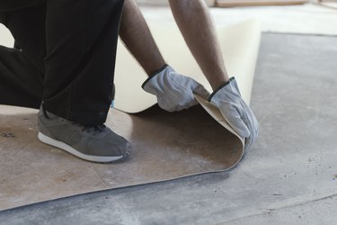 Contractor removing an old linoleum flooring