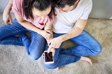 Couple using smartphone together