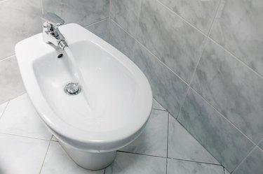 Bidet with running water top down, with copy space.