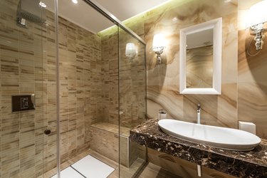 Luxury decorated bathroom, glass shower, sink and mirror