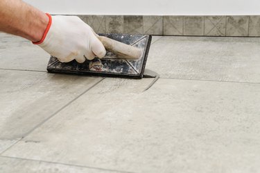 Grouting ceramic tiles.