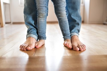 Beautiful young family. Bare feet of father and daughter.