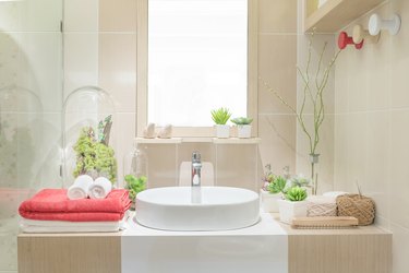 Washbasin with towel and decoration in bathroom