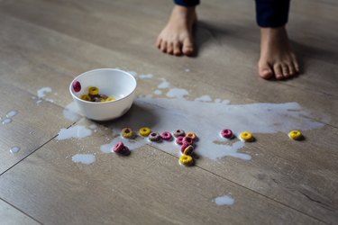 Spilled bowl of milk and cereal