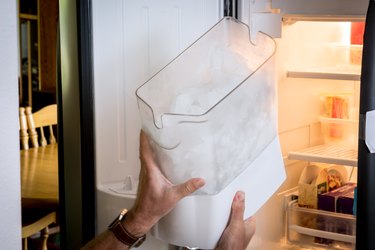 Man demonstrates how to remove an ice cube maker