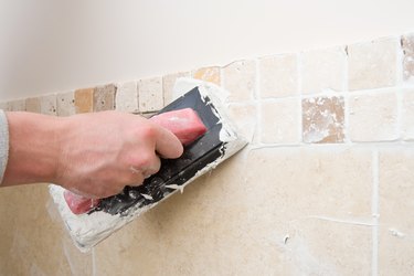 A decorator grouting tiles