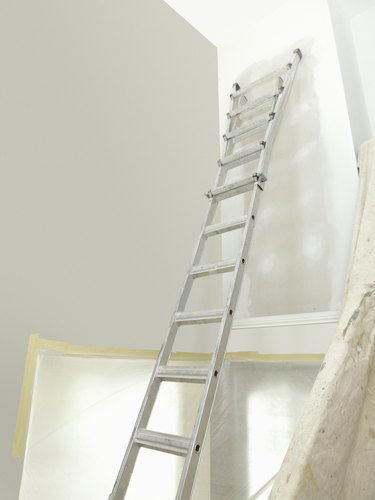 Ladder leaning against an unfinished wall