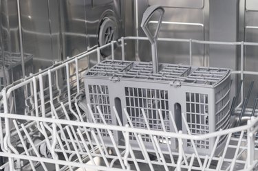 front view of gray grates of a dishwasher without dishes