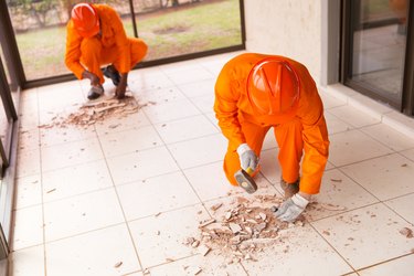 contractors removing old floor tiles