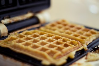 Waffle iron with fresh golden waffles