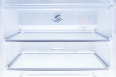 inside of clean and empty refrigerator with shelves, good background for health or diet concept
