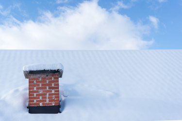 Chimney roof house under winter snow