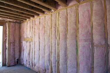 Wall of pink insulation in house