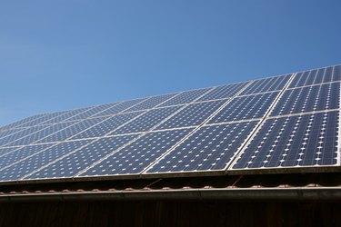 Solar panel on roof and sky background.