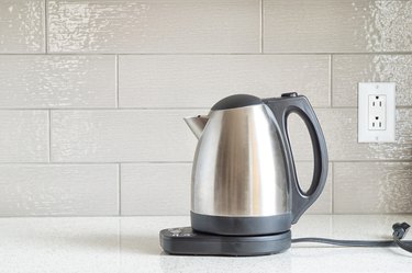 Electric stainless steel kettle on a granite counter top