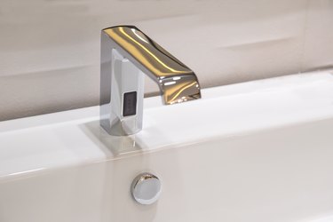 Bathroom faucet in polished chrome powered automatic by sensor. object about home Improvement.