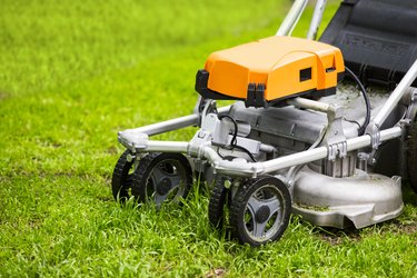 Lawn mower on a fresh lawn in the garden