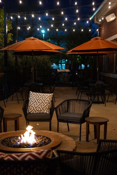 Outdoor patio with lights and a fire pit