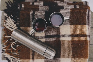 winter picnic on the snow. Hot tea, thermos on blanket.