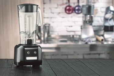 Blender and wooden table in kitchen