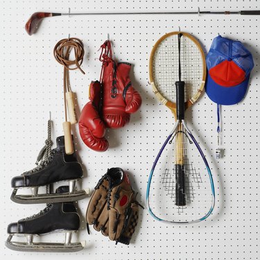 Sports Equipment hanging from pegboard.
